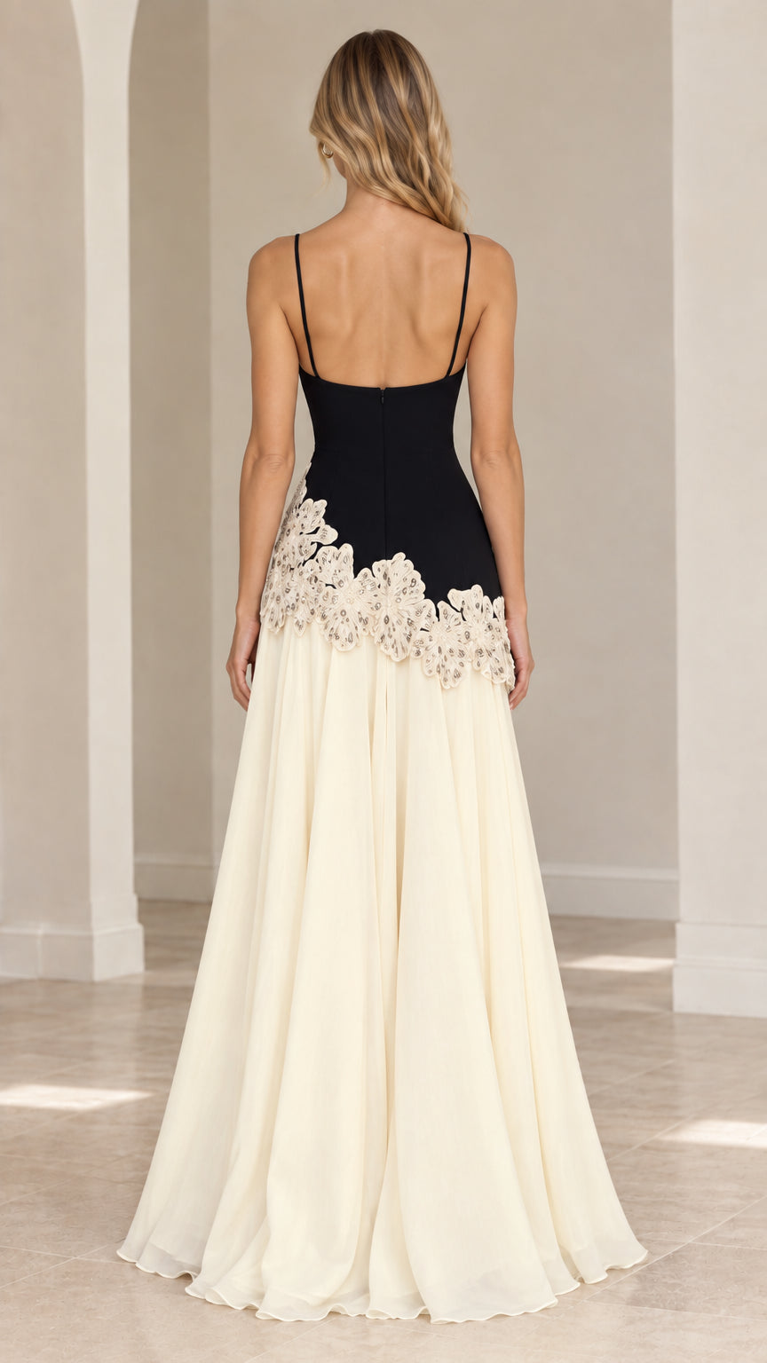 Back view of black and cream formal gown highlighting low back and maxi length