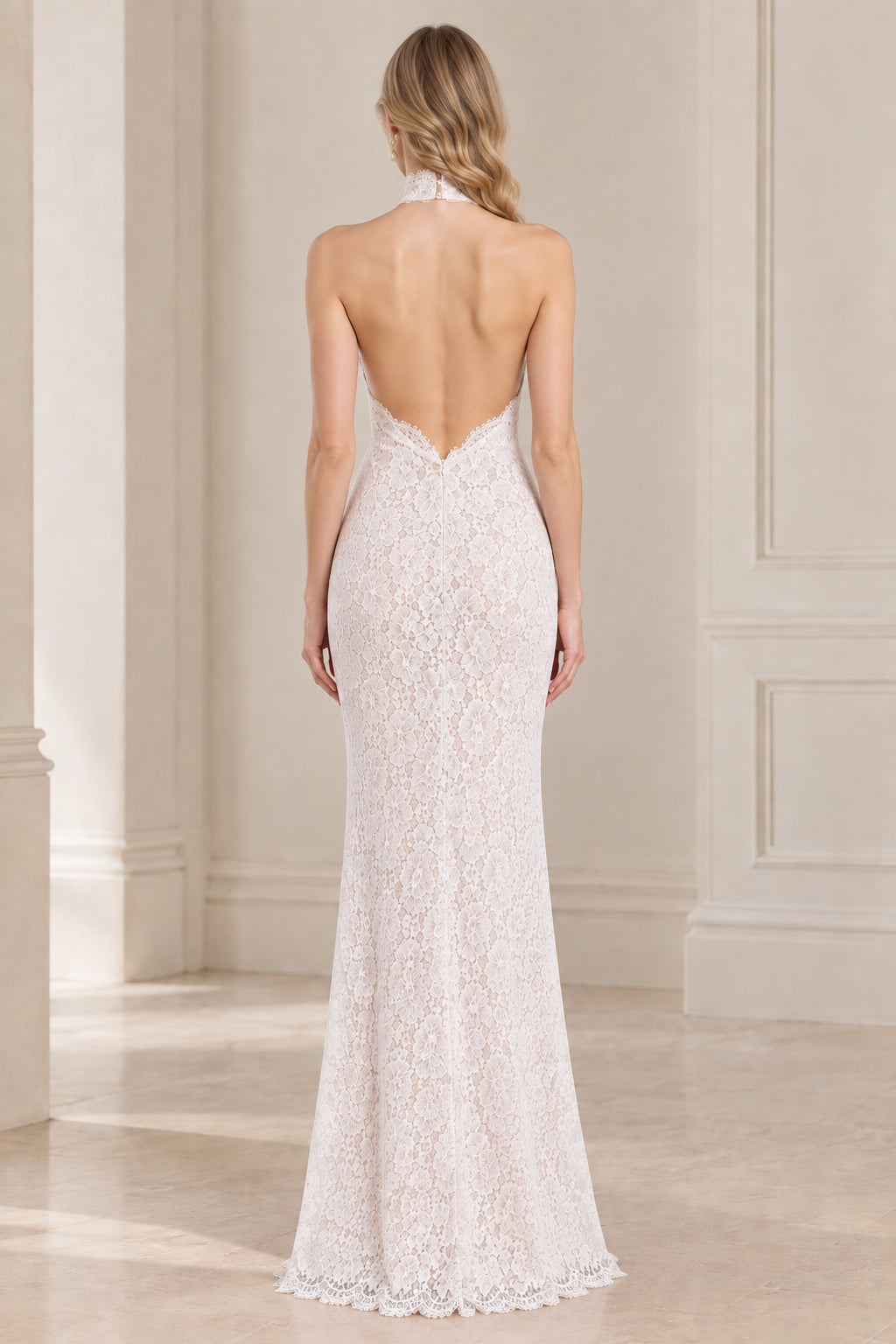 Back view of white halter dress showing open low back design
