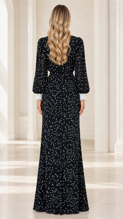 Back view of model in black polka dot floor-length dress