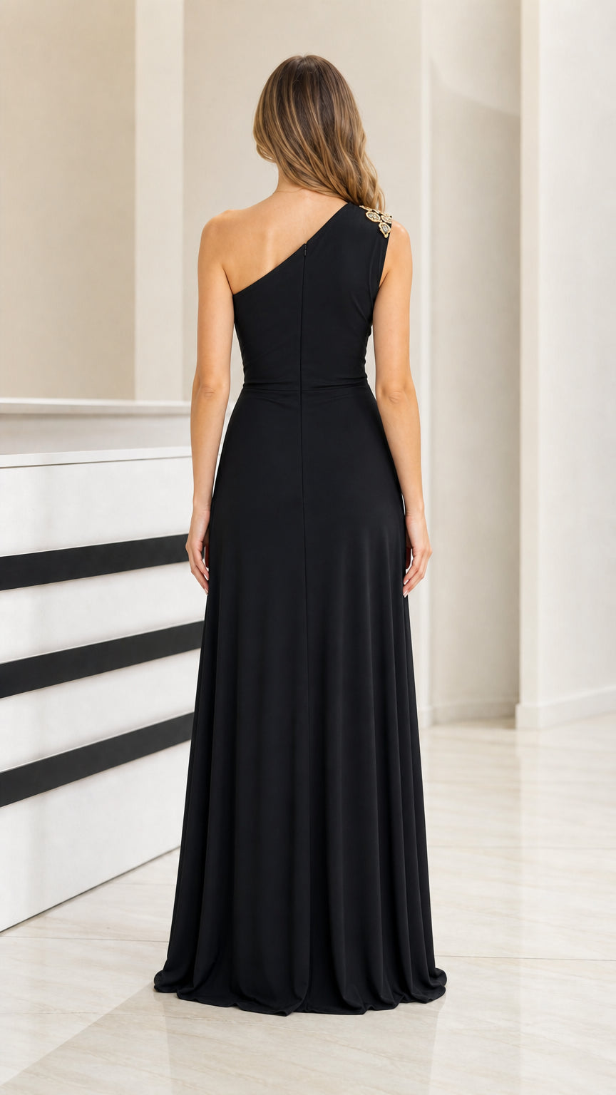 Back view of black one-shoulder floor-length gown