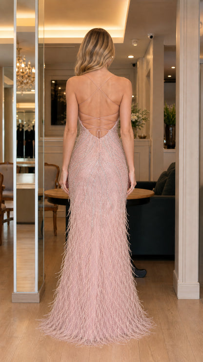 Back view of pink feathered evening gown showing lace-up details