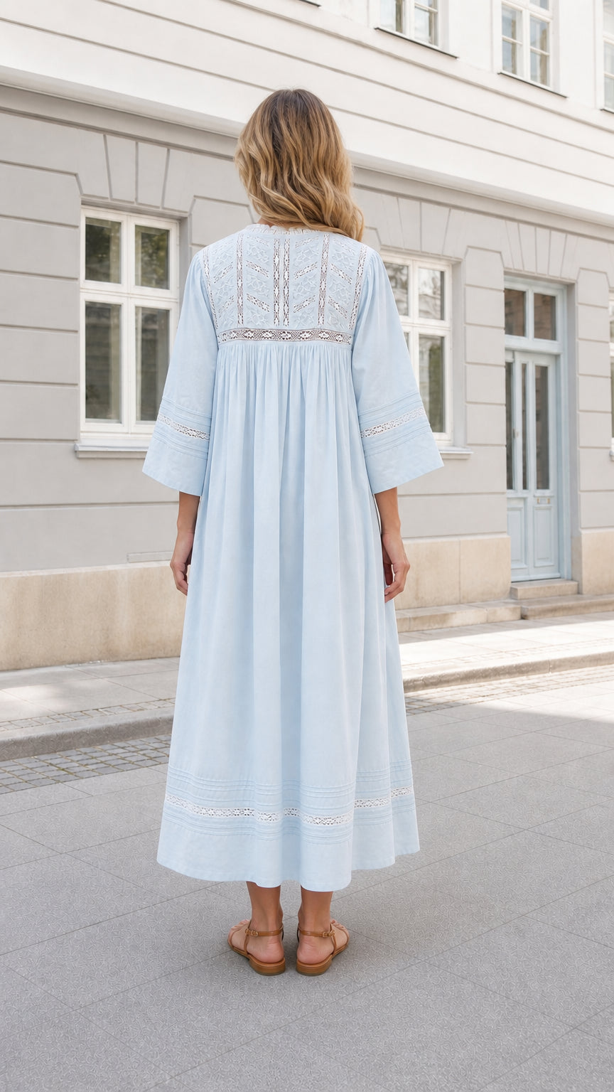 Back view of woman wearing Light Blue flowing maxi dress with lace yoke