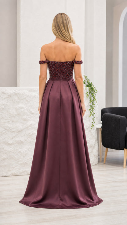 Back view of burgundy formal gown showing satin overskirt
