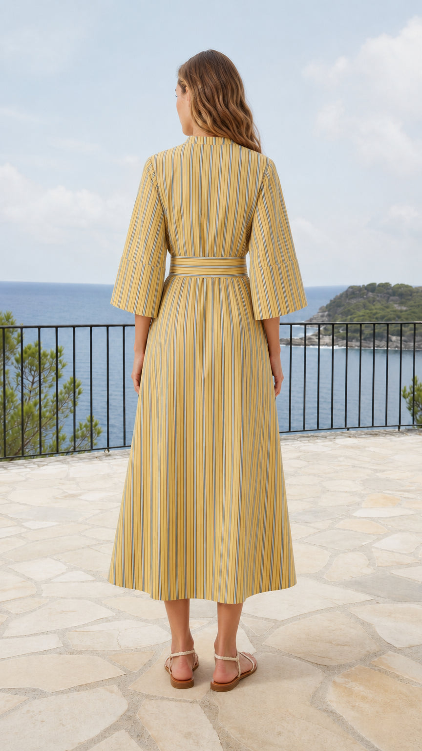 Back view of model wearing yellow vertical striped midi dress