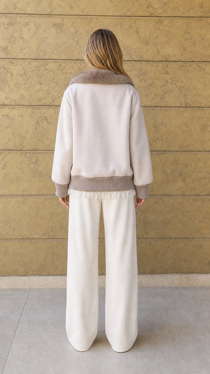 Back view of cream relaxed fit jacket with ribbed hem