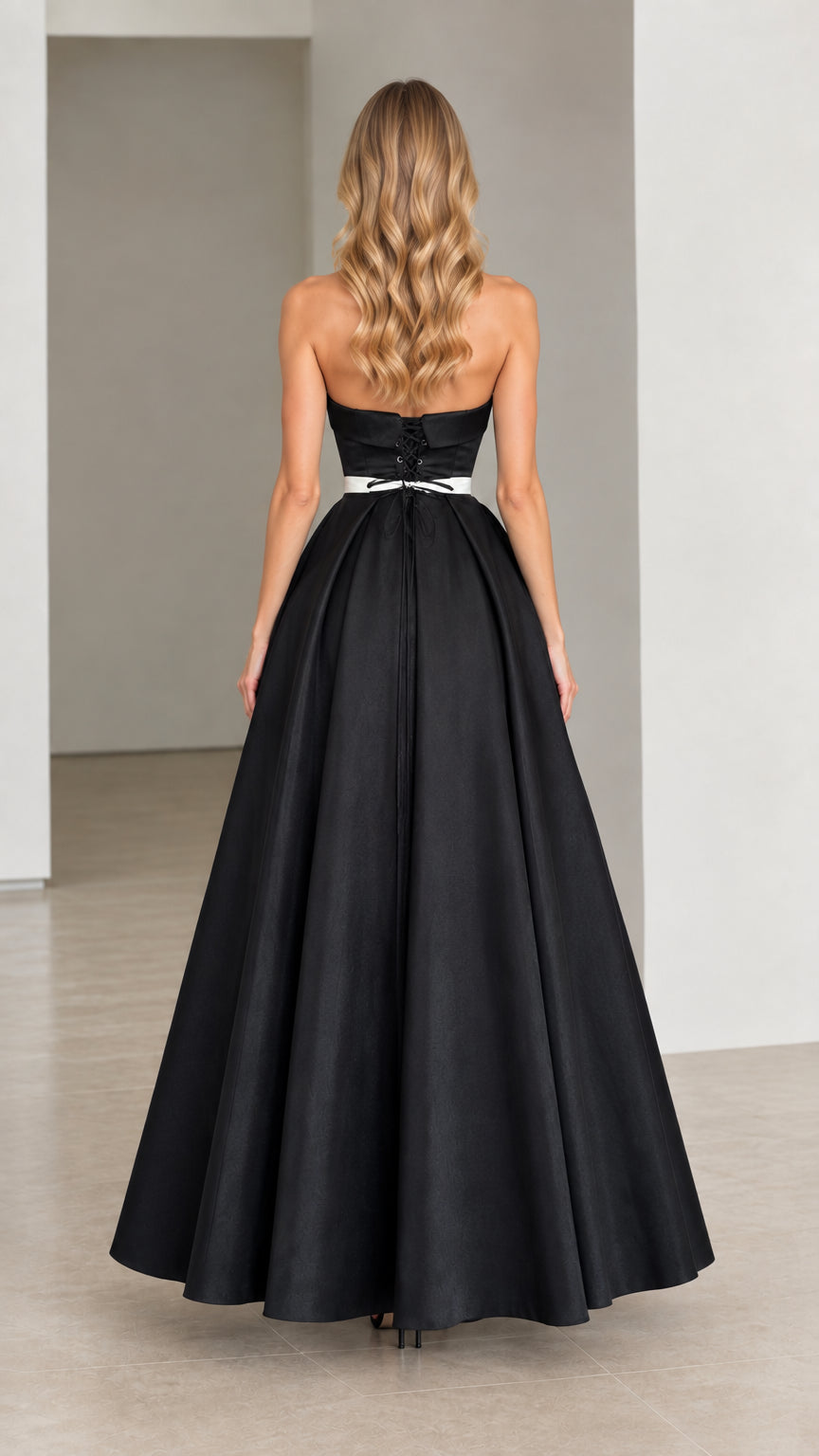 Rear view of strapless black gown showing lace-up corset back detail