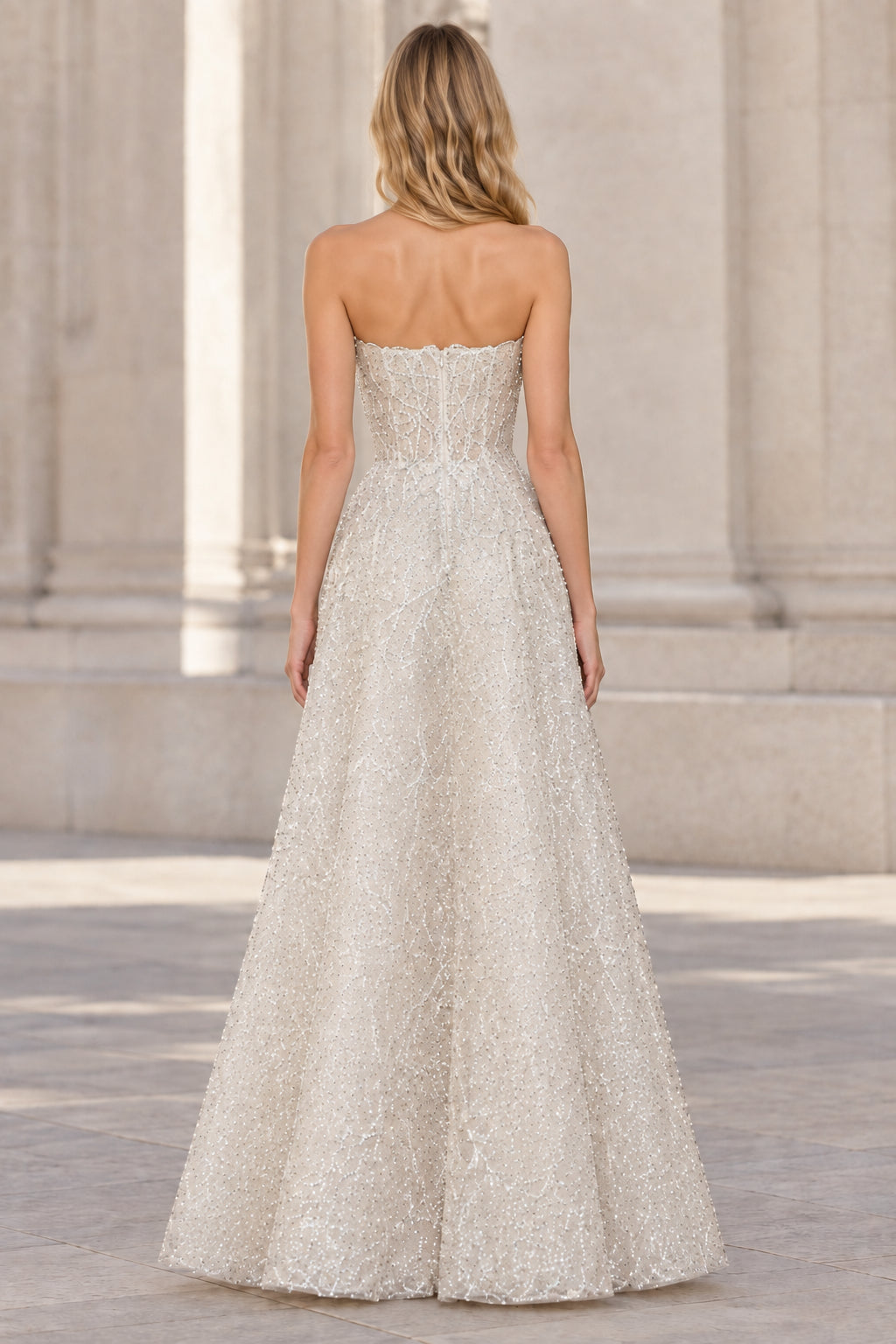 Back view of silver strapless floor-length formal gown