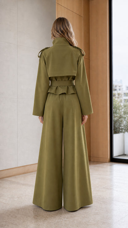 Back view of woman wearing khaki trench jacket and wide-leg trousers