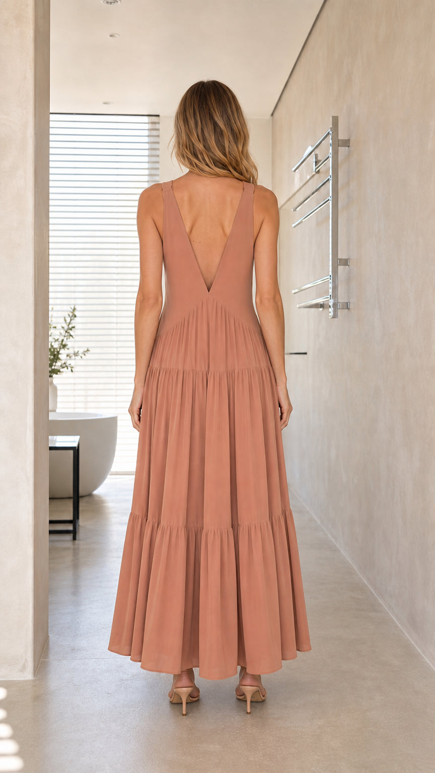 Model wearing Dusty Rose maxi dress, back view showing V-back design