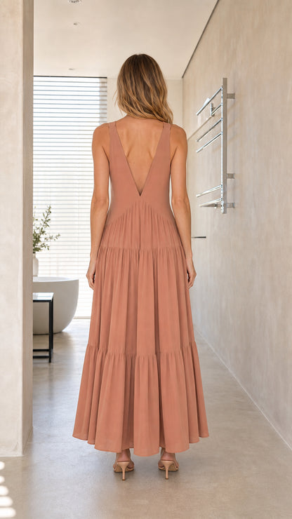 Model wearing Dusty Rose maxi dress, back view showing V-back design