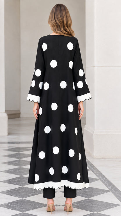 Back view of model showcasing the Black polka dot A-line tunic and pants set