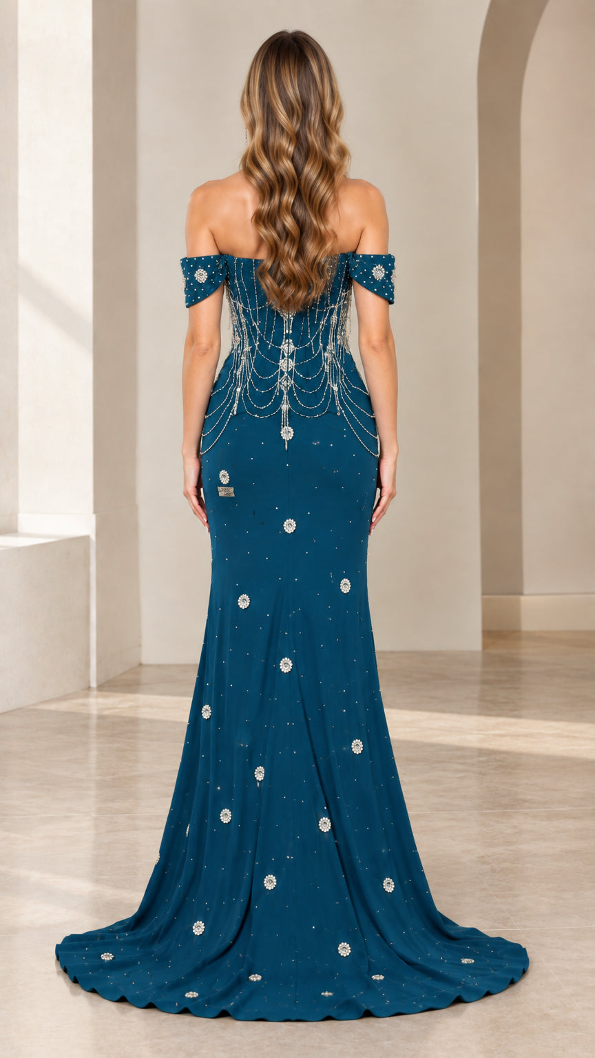 Back view of teal blue off-the-shoulder gown showing beaded back and train