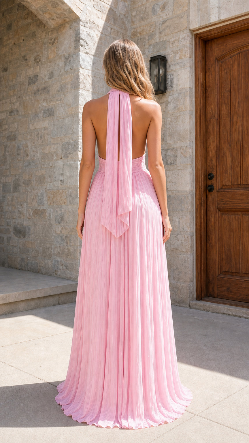 Model wearing pink pleated halter maxi dress back view