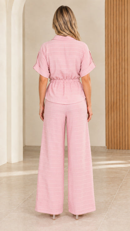 Back view of model showing soft pink relaxed fit wide-leg matching two-piece set