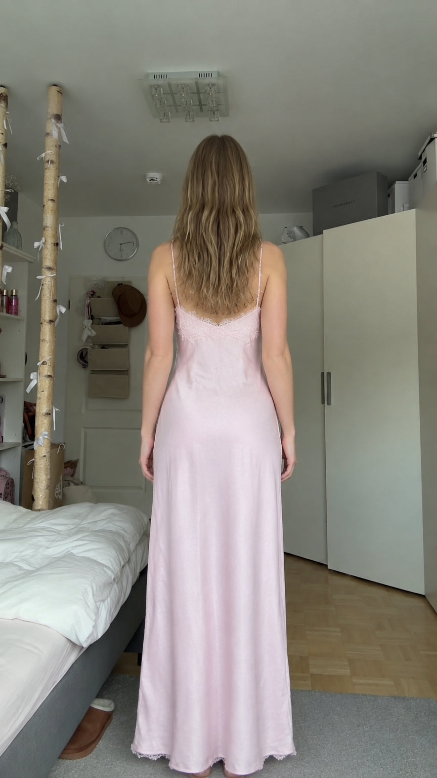 Back view of model in floor-length light pink satin slip dress