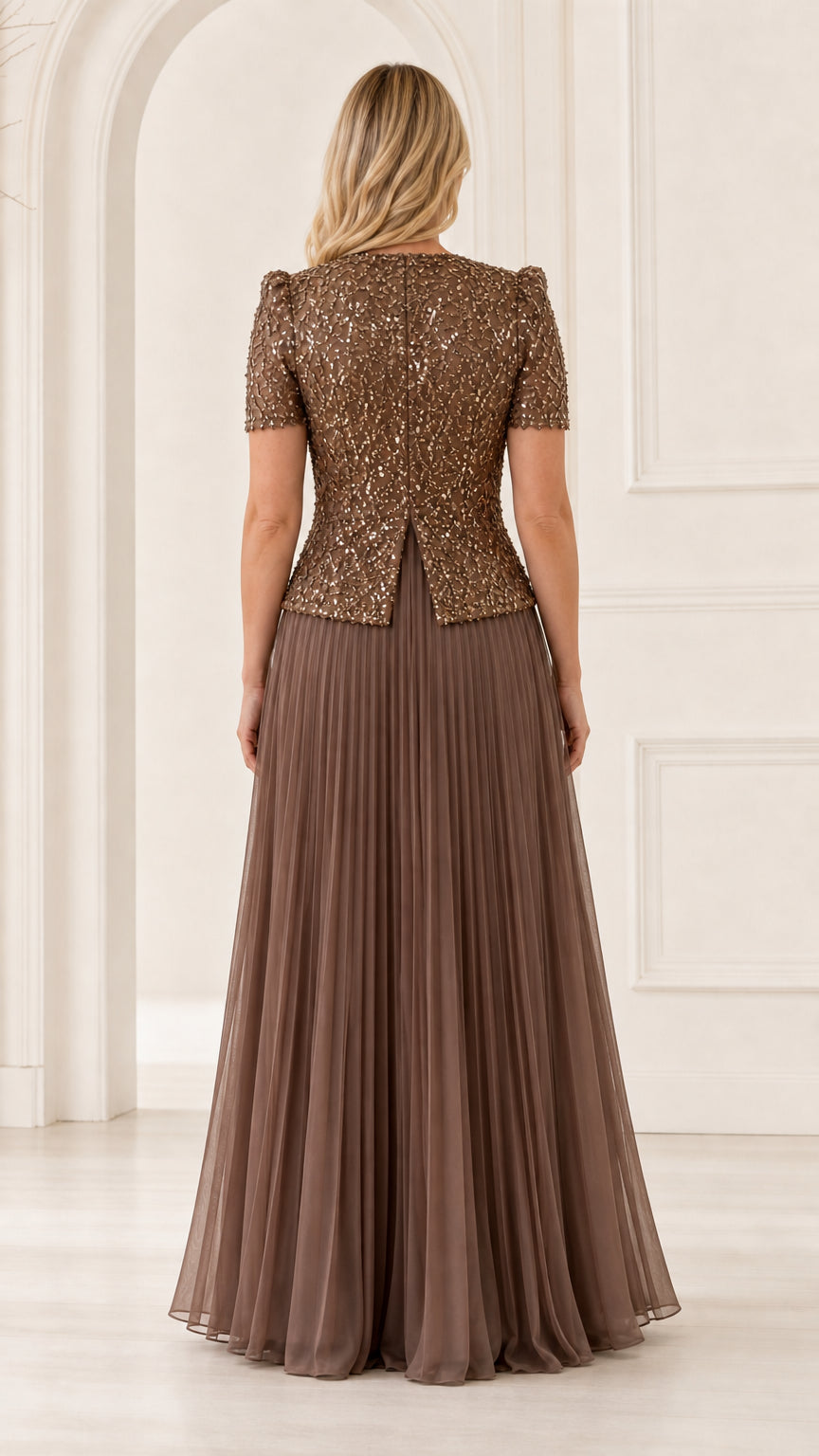 Back view of woman wearing mocha brown sequined peplum top evening gown with pleated skirt