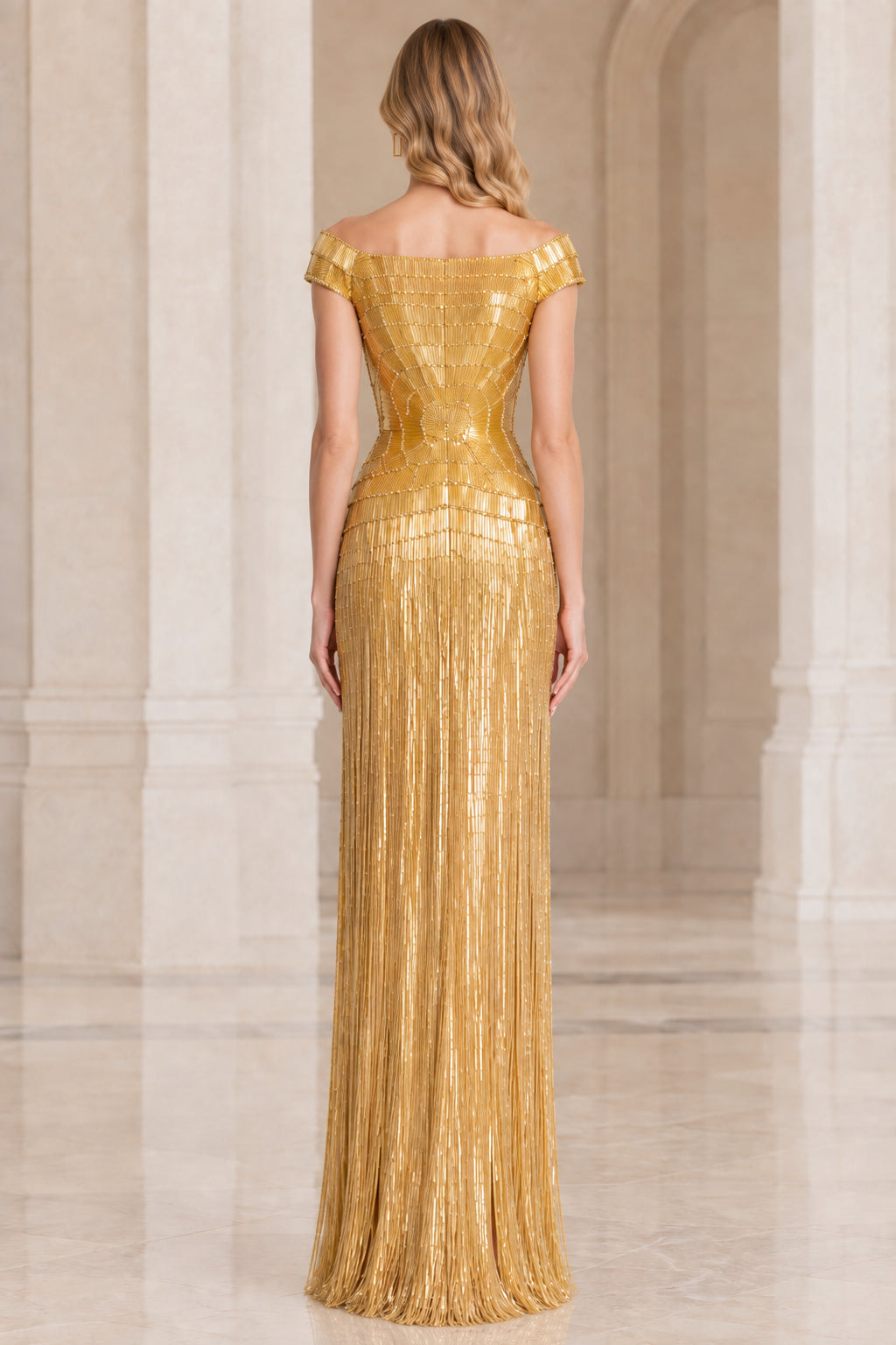 Back view of woman wearing gold off-the-shoulder embellished column dress