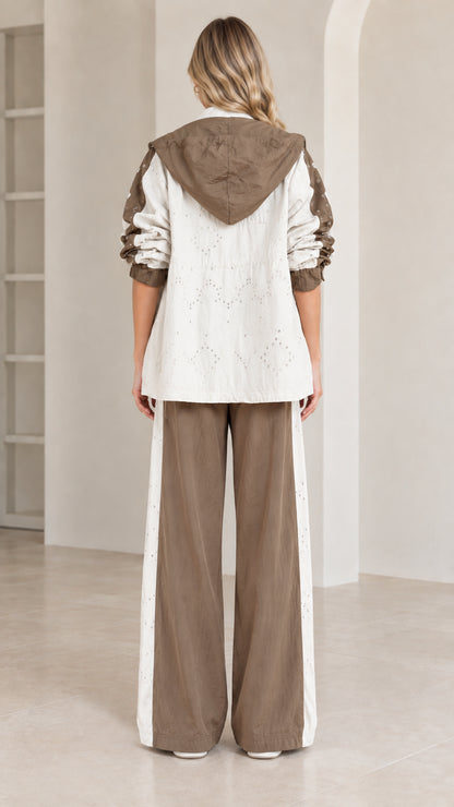 Back view of model wearing hooded jacket and wide-leg track pants in mocha