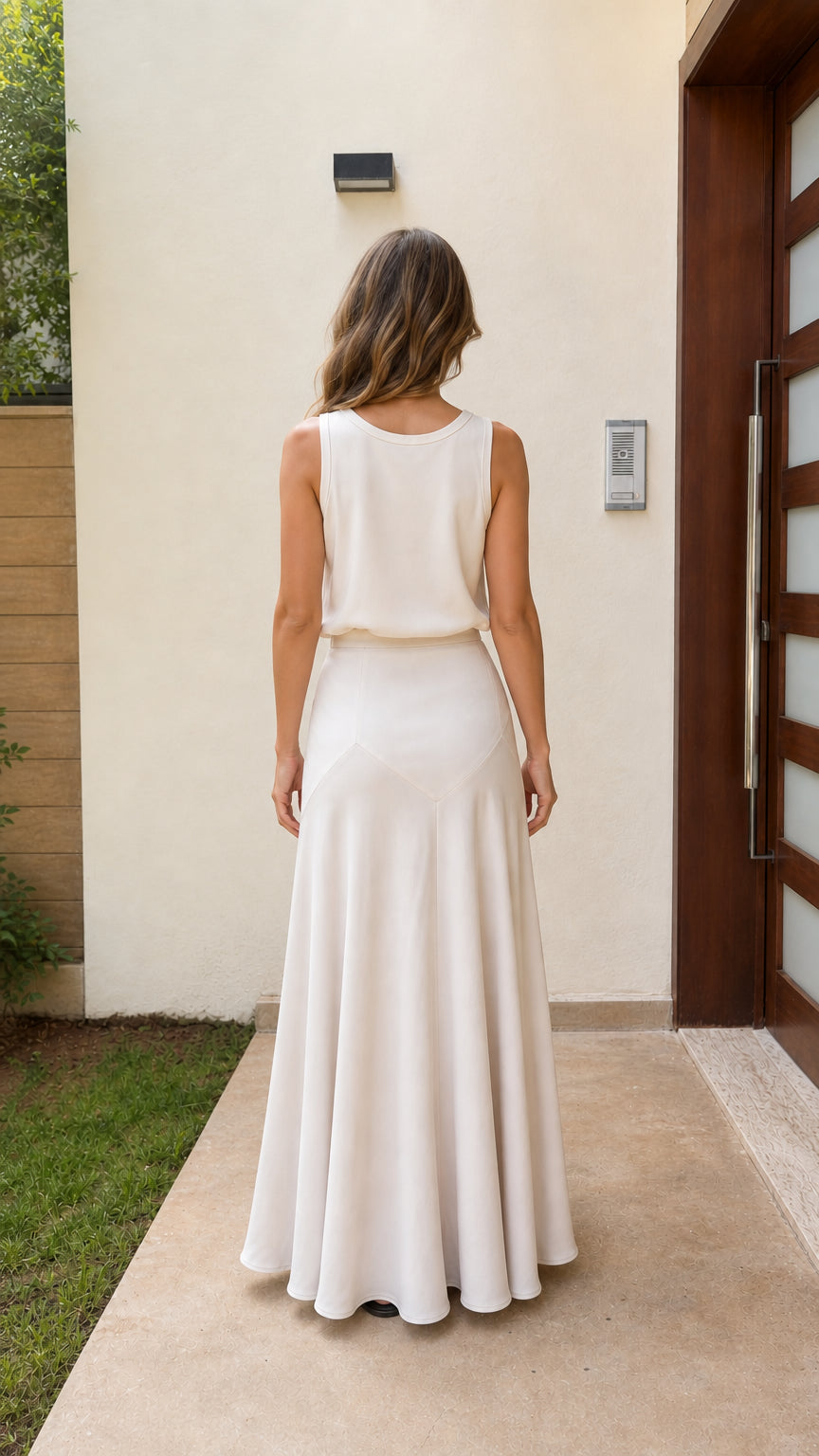 Back view of woman wearing ivory sleeveless maxi dress