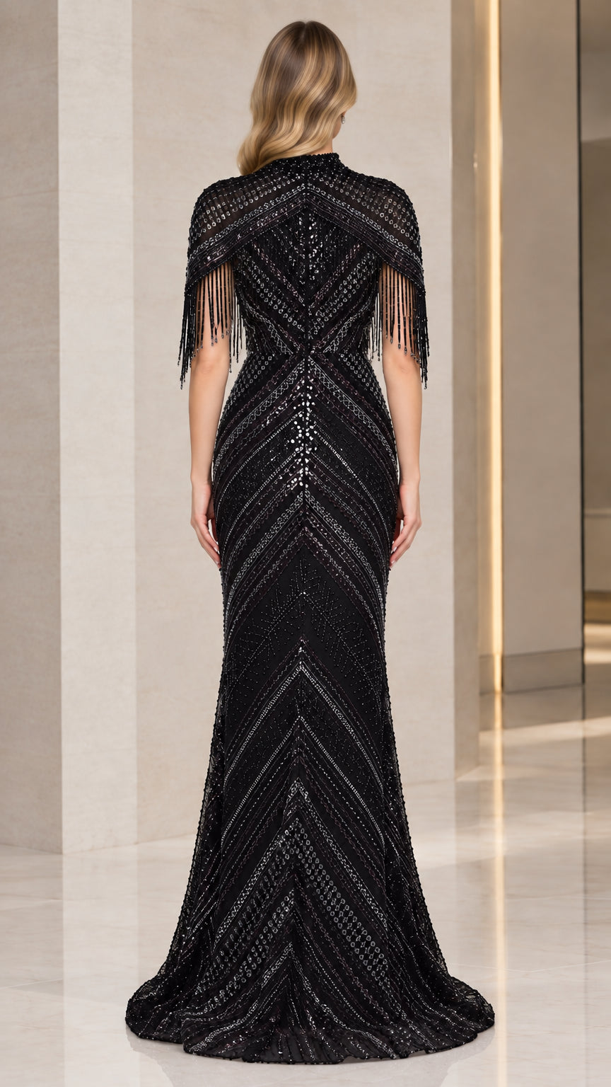 Back view of model in black sequin capelet evening dress showcasing chevron beading pattern