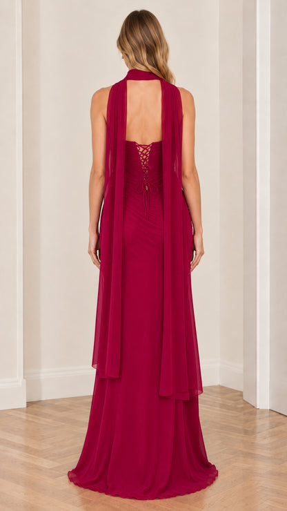 Back view of berry red formal gown showing lace-up corset and trailing scarf