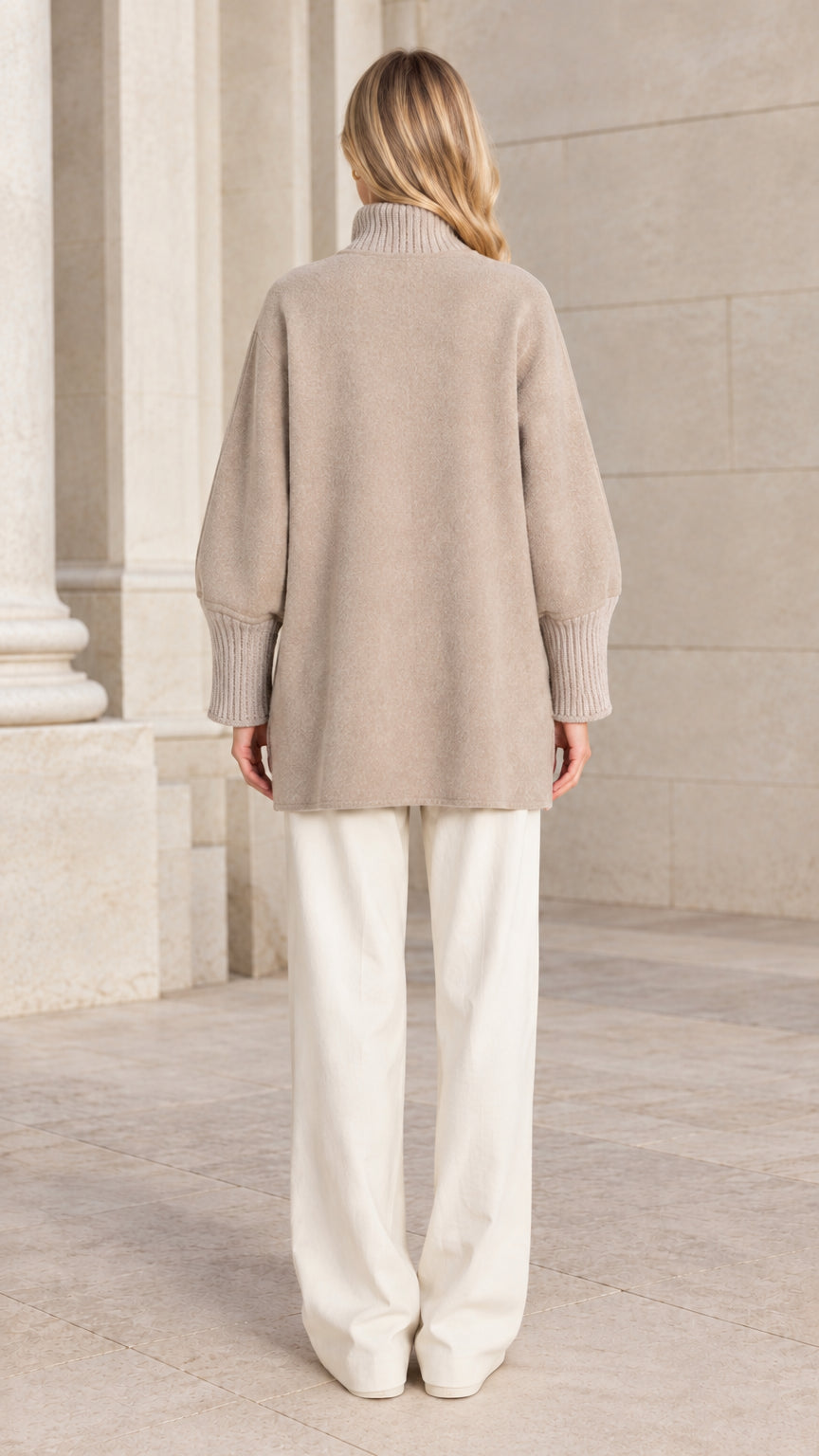 Back view of a woman wearing a relaxed beige outerwear jacket
