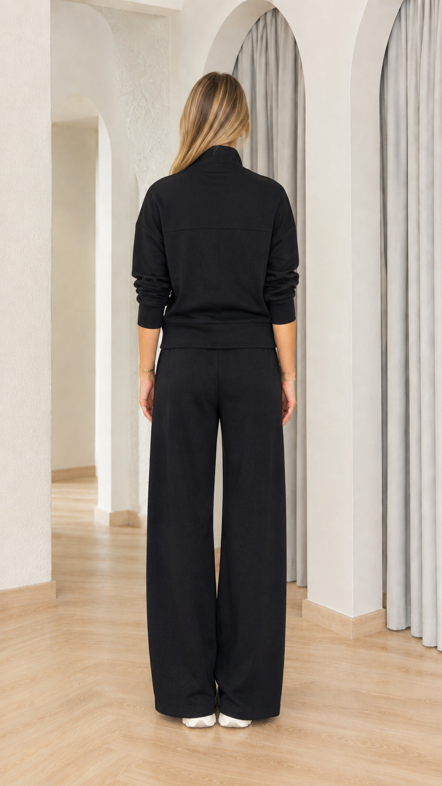 Back view of woman wearing black relaxed fit lounge set