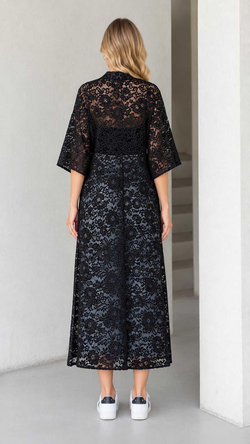 Back view of black lace midi duster showing sheer textured floral pattern