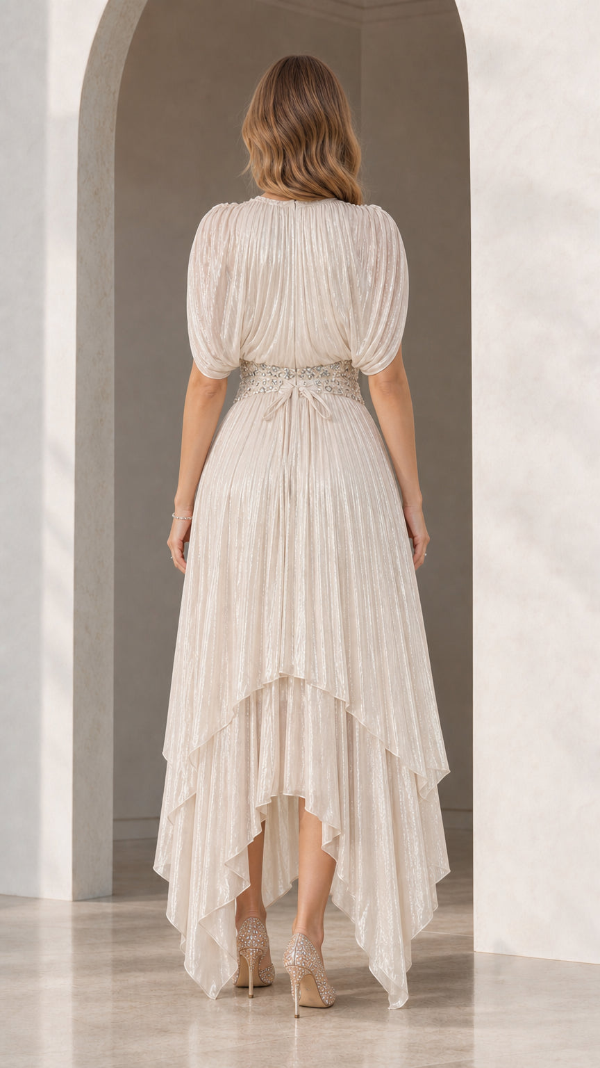 Back view of Champagne shimmer pleated evening dress showing high-low tiered hem