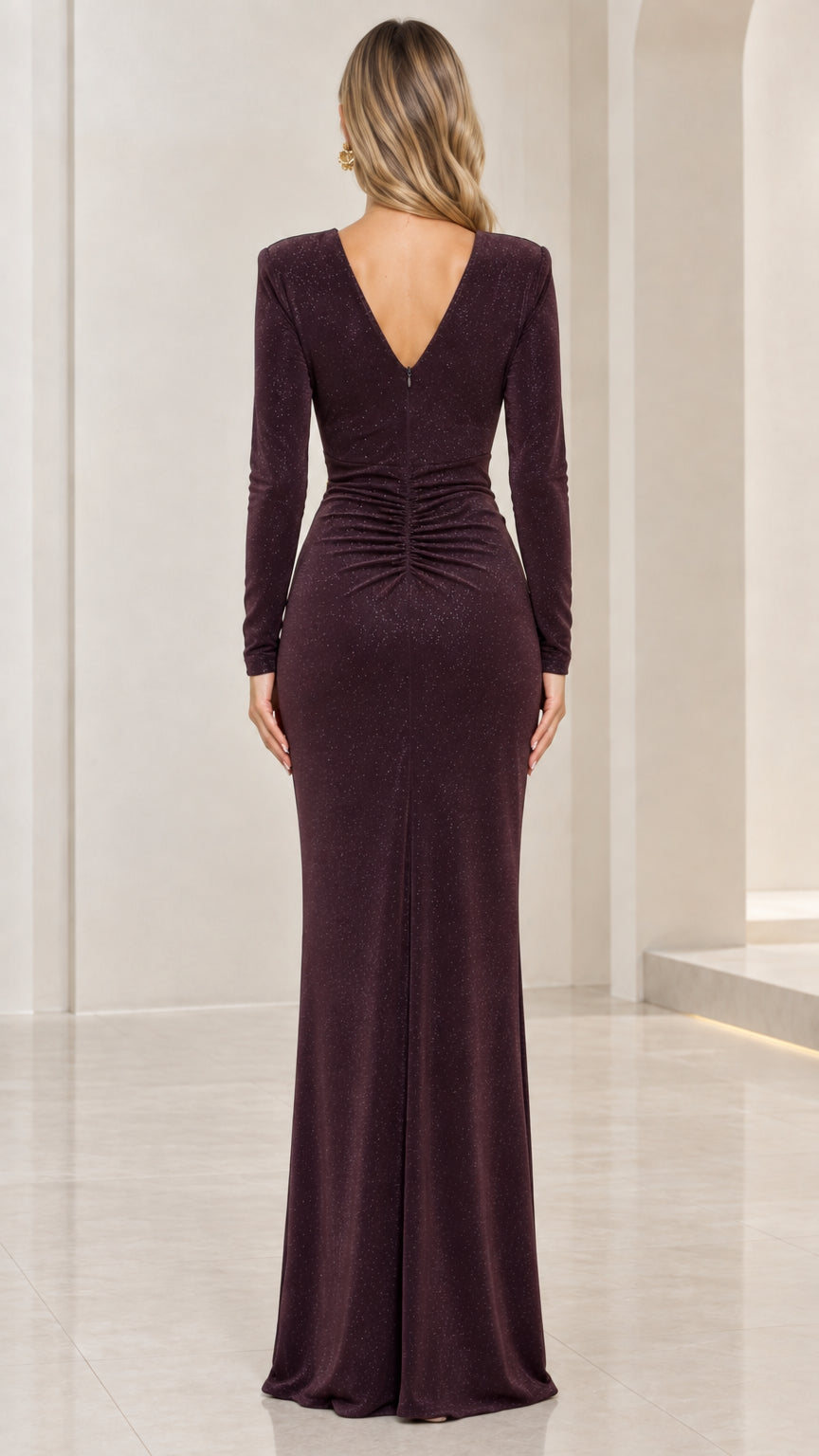 Back view of model in burgundy long sleeve evening dress showing deep V-back and ruching