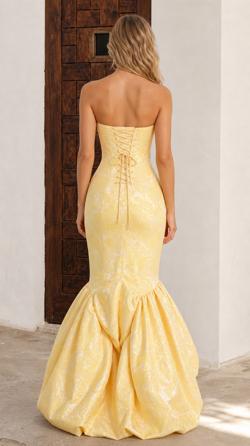 Back view of butter yellow evening gown featuring lace-up corset back