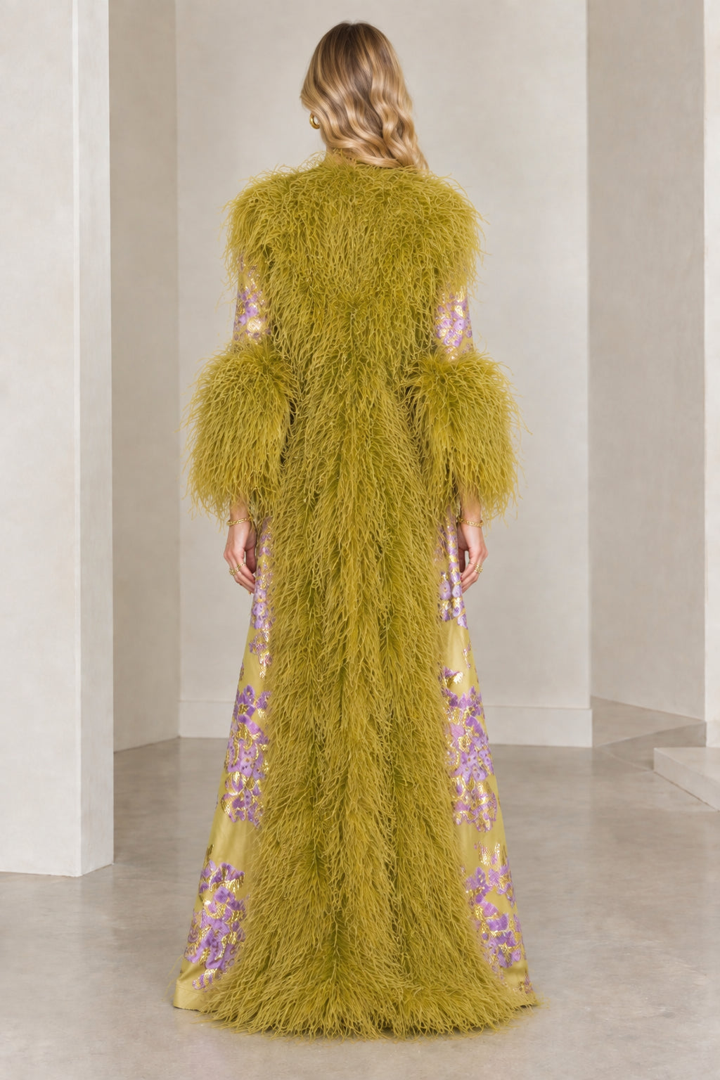 Back view of olive green floral brocade duster coat showing textured feather trim detailing