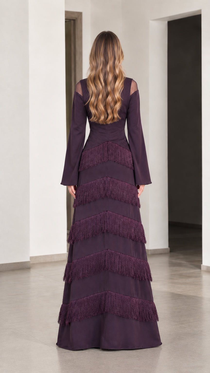 Back view of Plum long sleeve evening gown with tiered fringe skirt