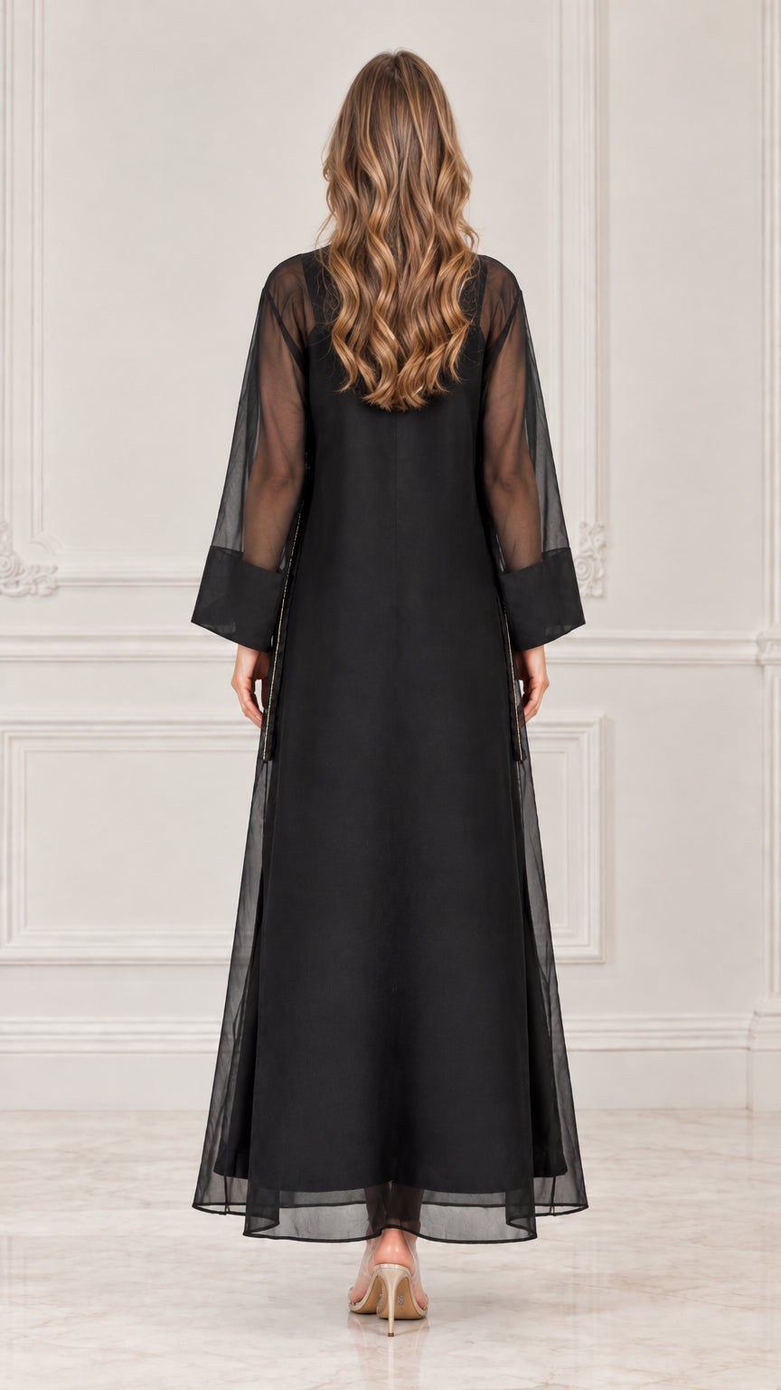 Back view of model wearing black sheer overlay long sleeve maxi dress