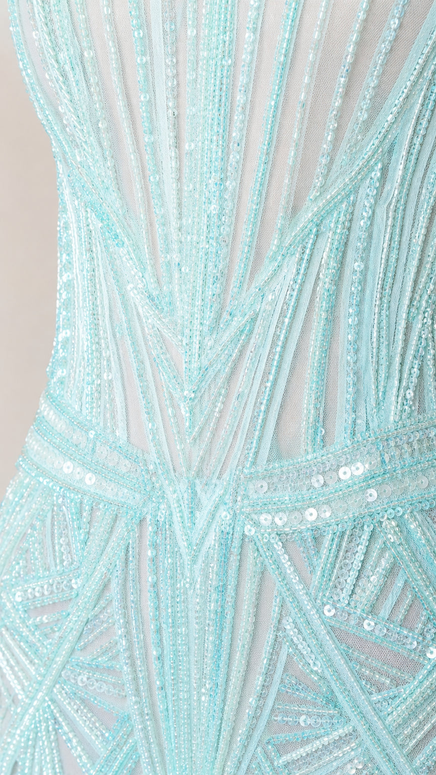 Close-up detail of geometric sequin and beading pattern on mesh fabric