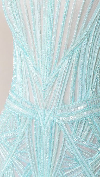 Close-up detail of geometric sequin and beading pattern on mesh fabric