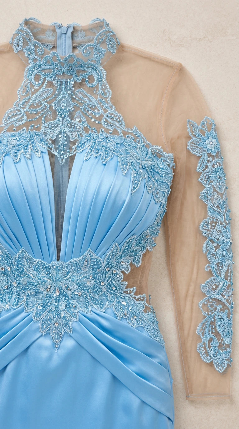 Close-up detail of sheer mesh bodice, intricate beading, and pleating on light blue gown