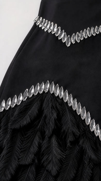 Close-up detail of crystal embellishments and feather fringe hem