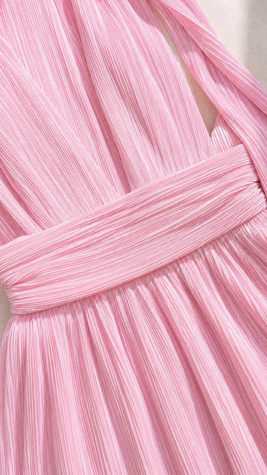 Close-up detail of pink pleated fabric and waistband