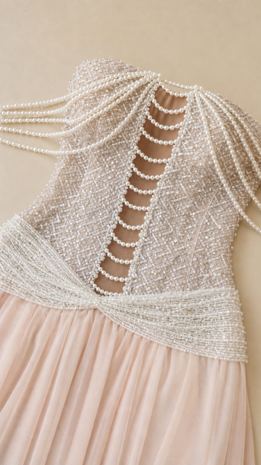 Detailed close-up of intricate pearl beadwork and cutout detail on corset bodice