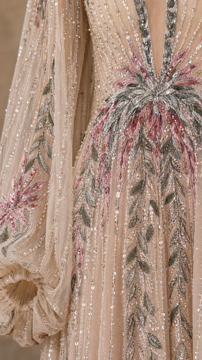 Close-up detail of intricate beadwork and embroidery on the bodice and sleeves