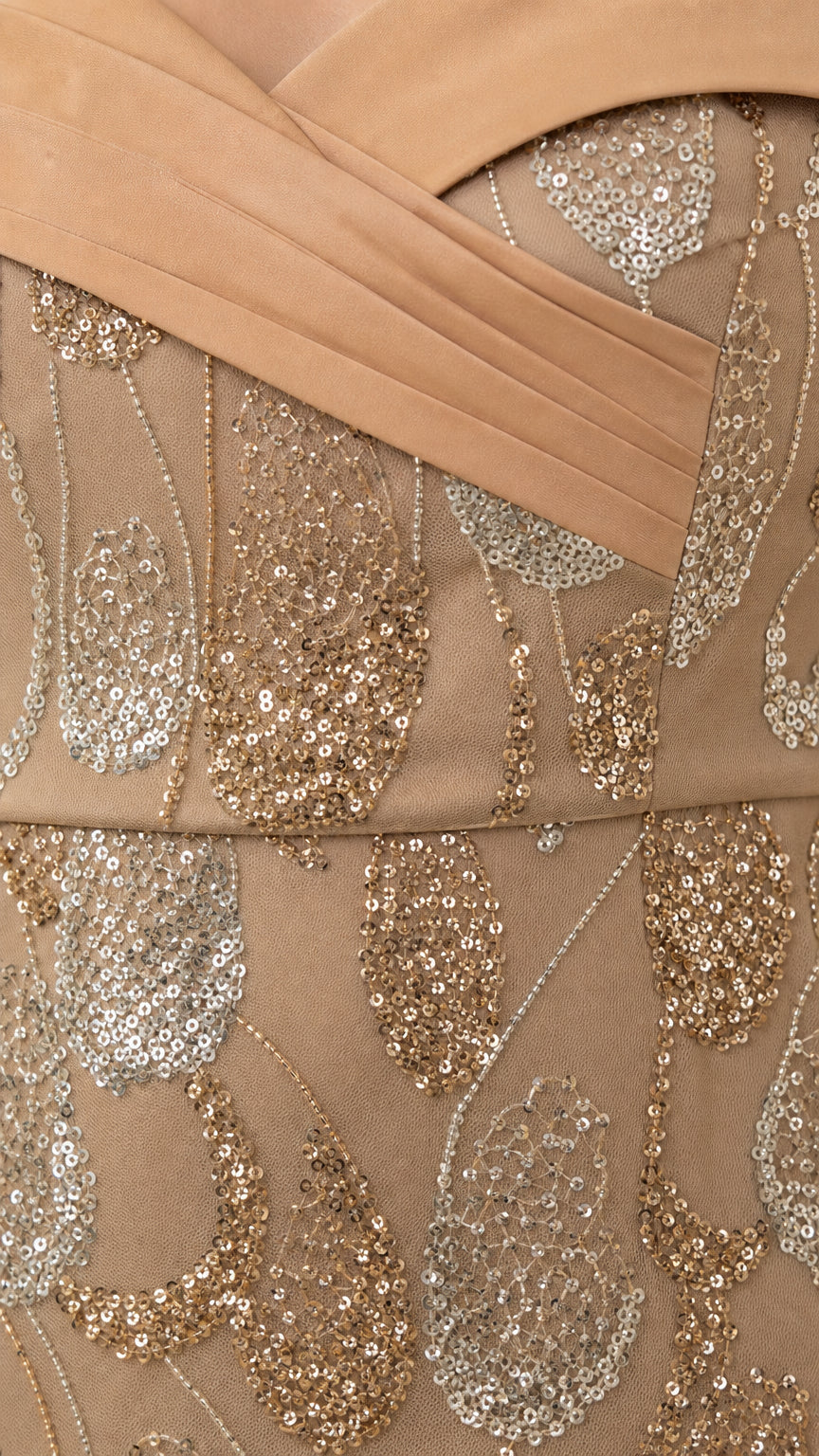 Close-up detail of pleated crossover neckline and shimmering sequin embroidery in champagne