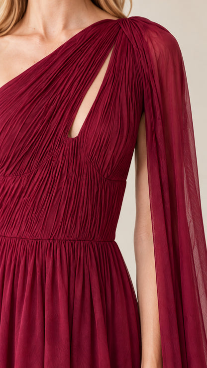 Close-up detail of pleated burgundy bodice with asymmetrical neckline cutout