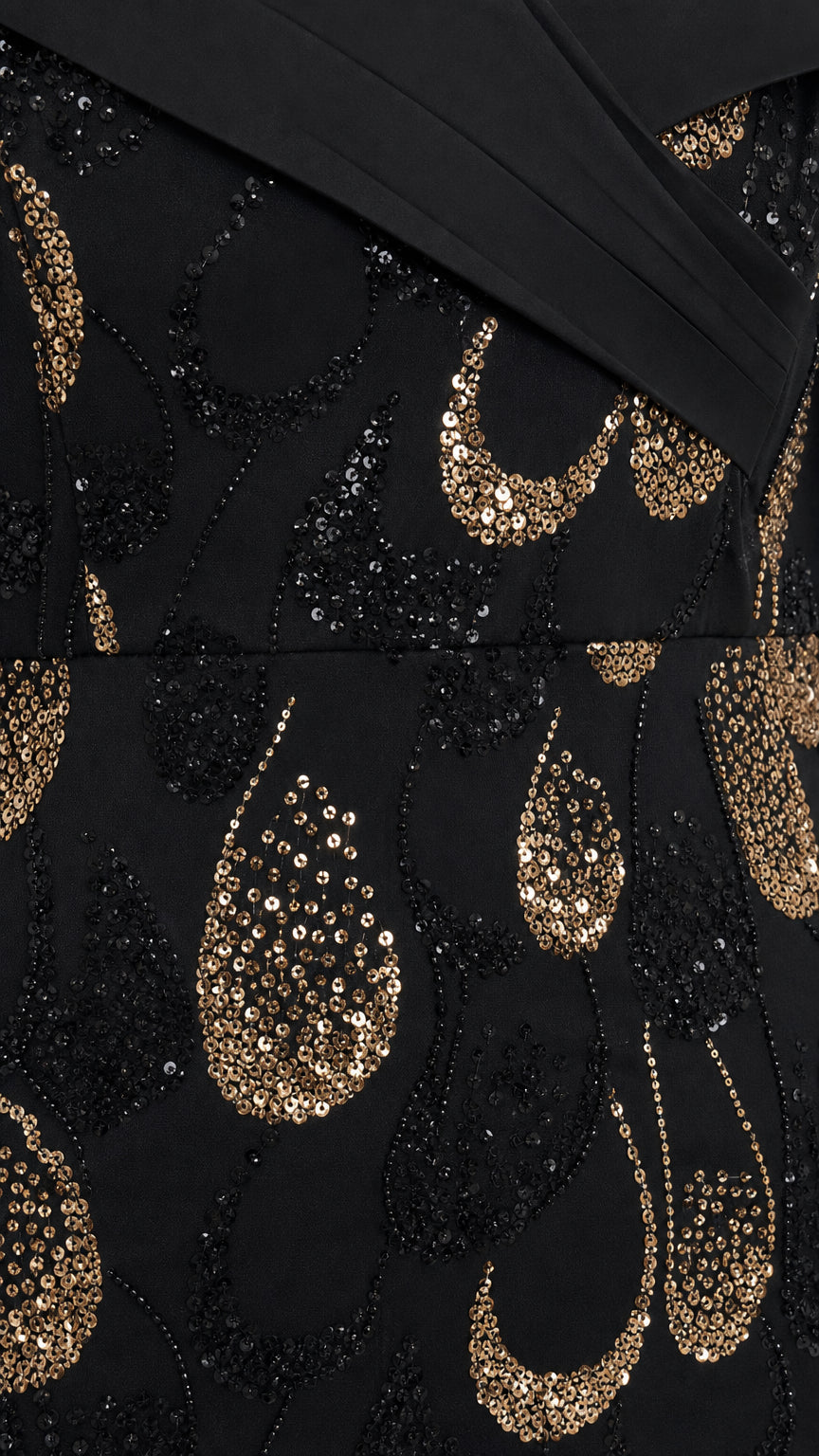 Close-up detail of black and gold teardrop sequin embroidery on mesh overlay