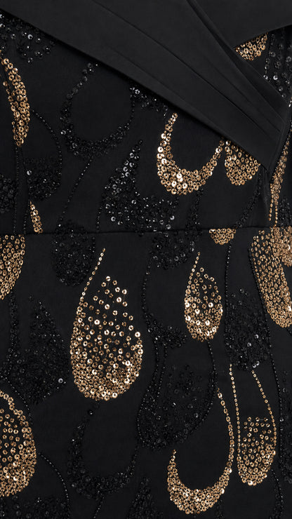Close-up detail of black and gold teardrop sequin embroidery on mesh overlay