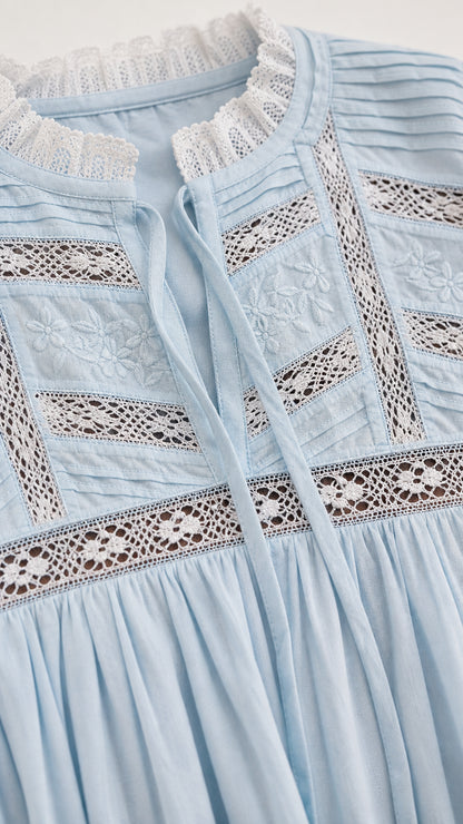 Close-up of Light Blue dress showing delicate lace insets, embroidery, and pin-tuck details