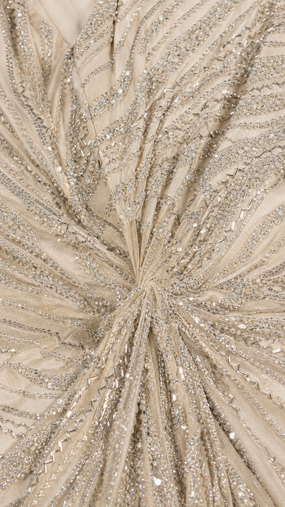 Close-up detailed texture of radiating beadwork and sequins gathered at the waist