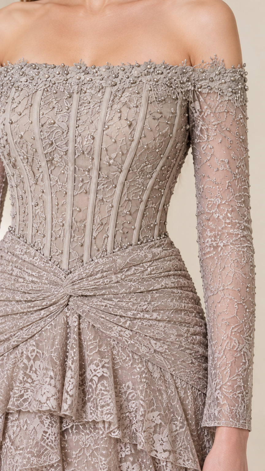 Close-up of beaded off-the-shoulder neckline, structured boned corset bodice, and draped waist