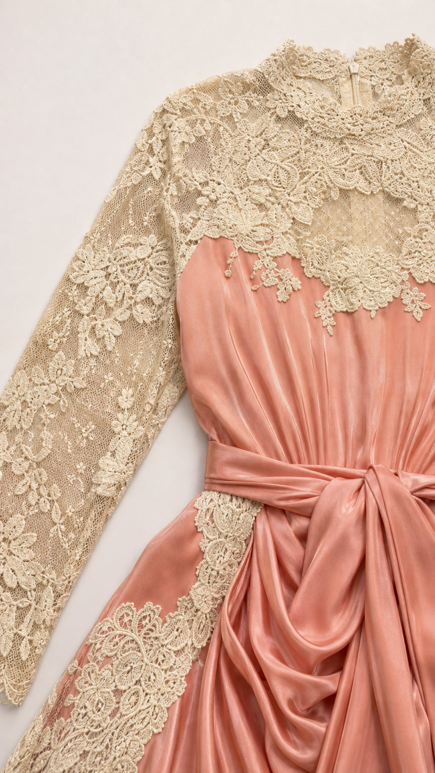 Close-up detail of champagne floral lace mock neck and dusty rose satin tie waist