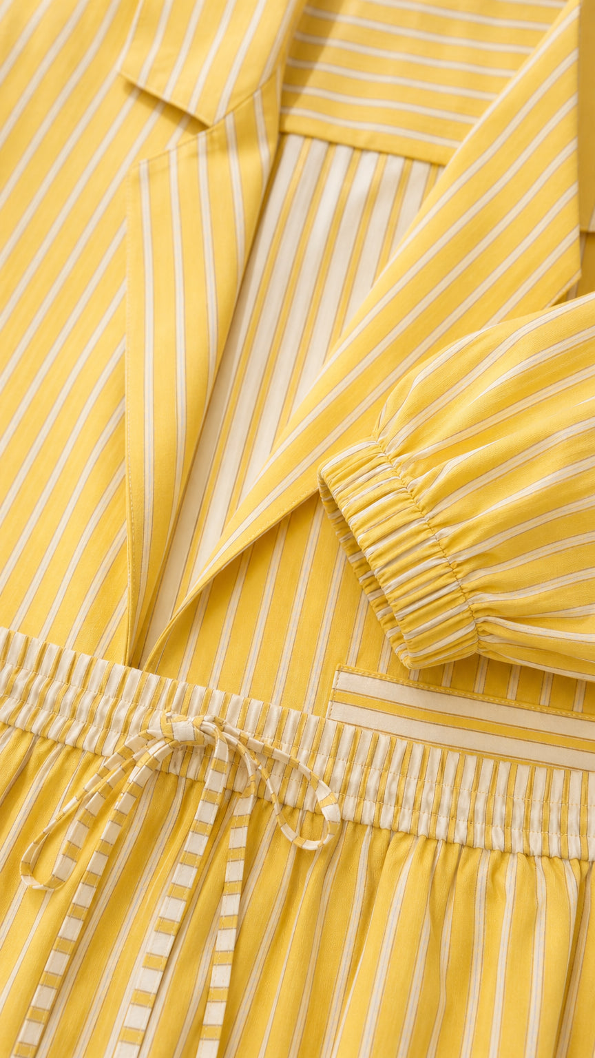 Close-up detail of yellow striped jacket collar, drawstring waist, and cuff elastic